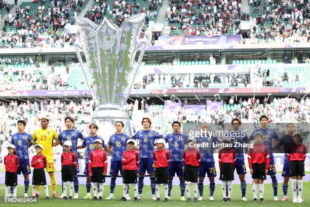 The players of Japan line up during the National Anthems prior to kick-off ahead of the AFC Asian Cup quarter final match between Iran and Japan at...