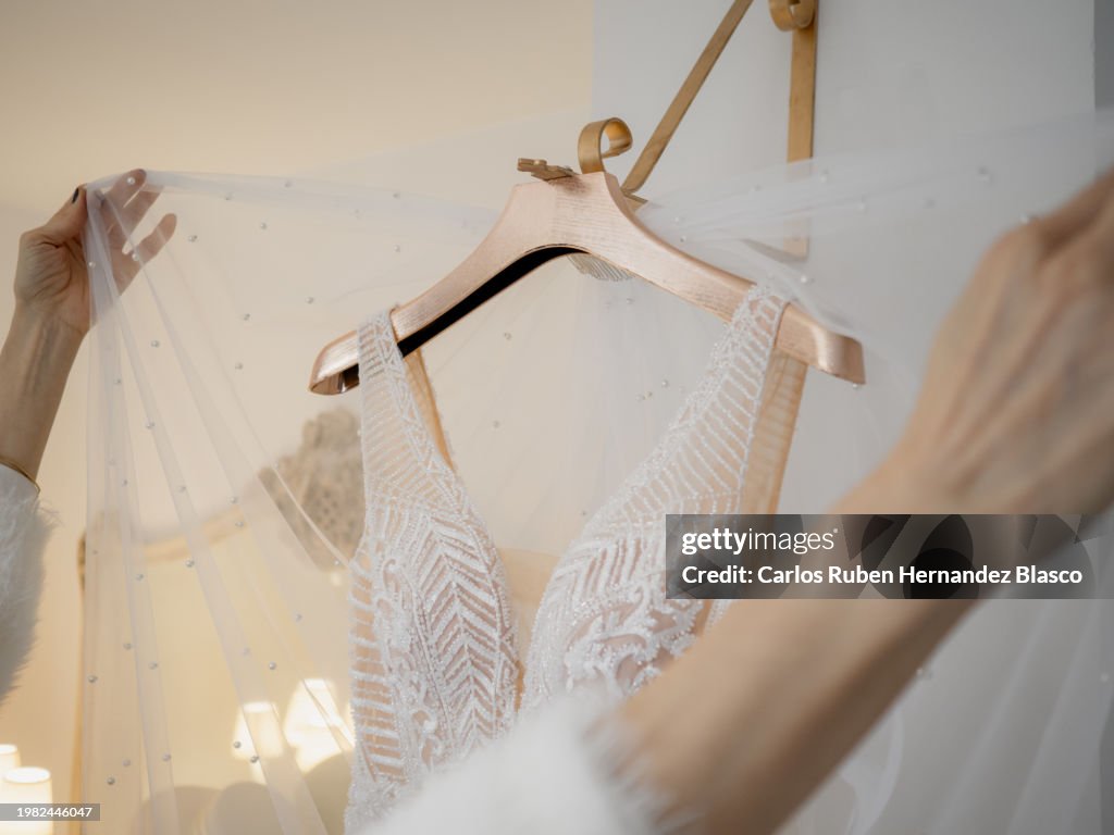 Dressmaker combining veils with a wedding dress