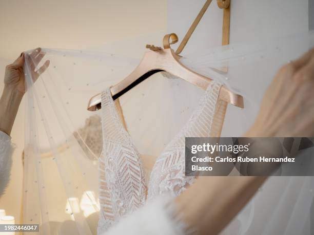 dressmaker combining veils with a wedding dress - trouwjurk stockfoto's en -beelden