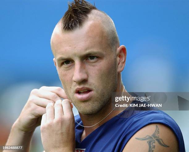 Clint Mathis forward of the USA's soccer takes off a little medal during the training at Daejeon World Cup stadium in South Korea, 13 June 2002. The...