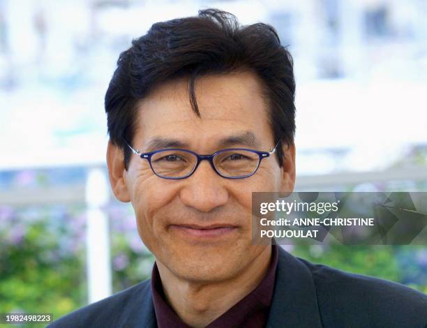 Korean actor Ahn Sung-Ki poses for photographers on a terrace of the palais des festivals during the photocall for their film 'Chihwaseon' during the...