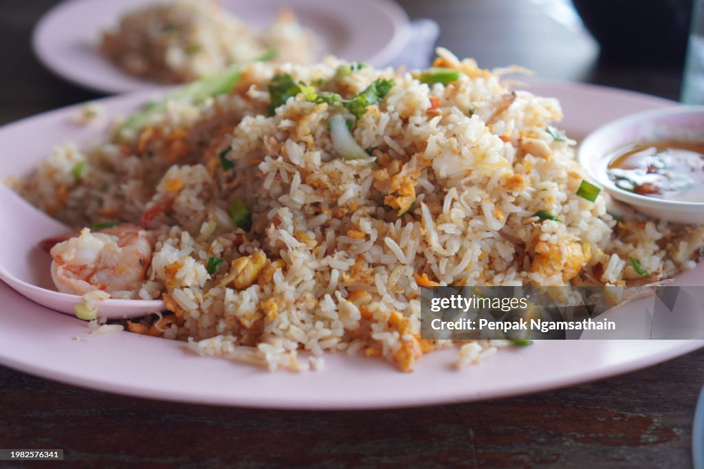Crab meat fried rice topped with Scrambled egg, style Thai food in white plate read to eat