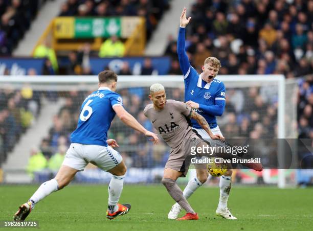 Richarlison of Tottenham Hotspur is challenged by Jarrad Branthwaite of Everton during the Premier League match between Everton FC and Tottenham...