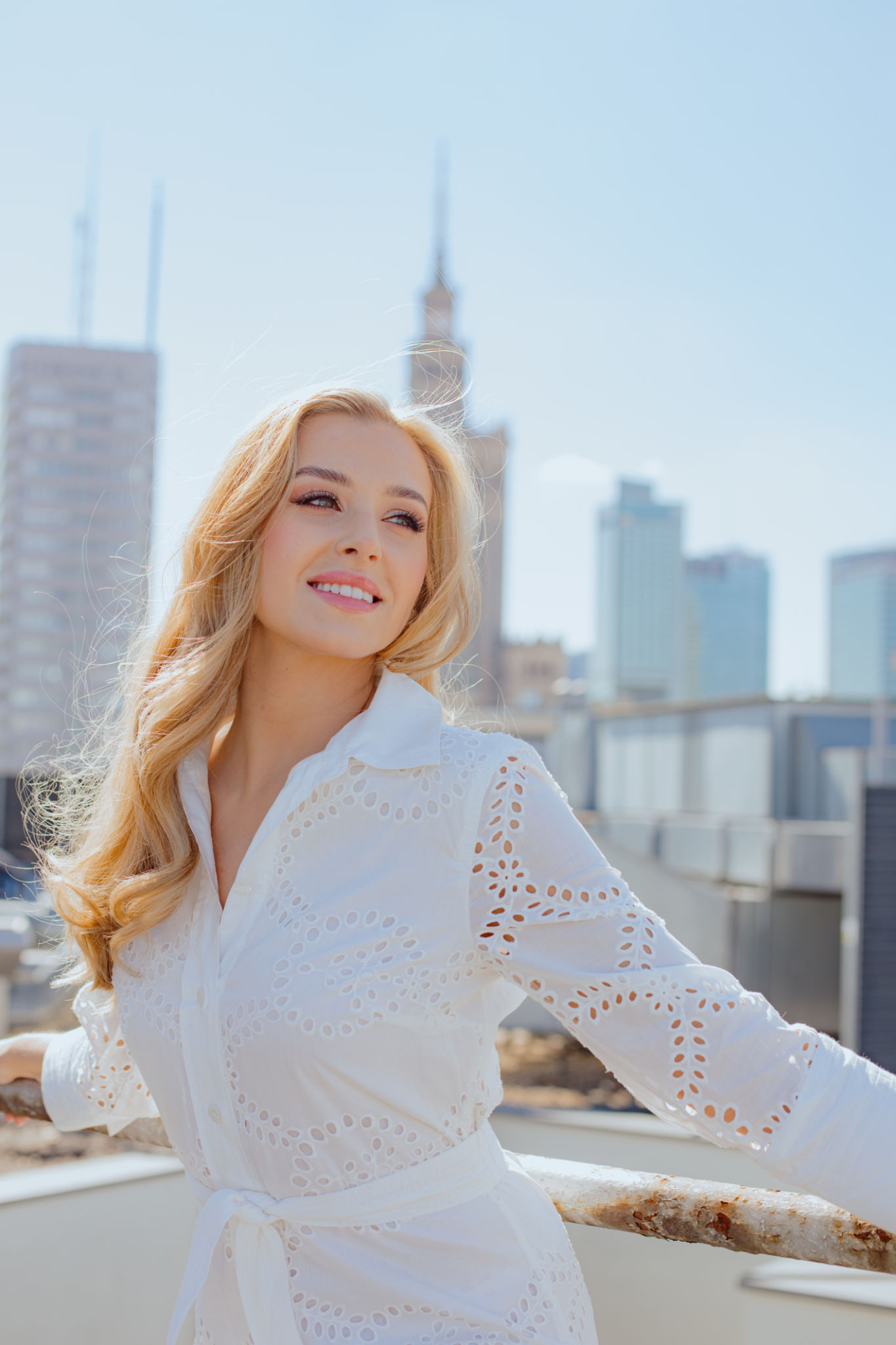 Positive emotions. Recreation and tourism. Enjoying life and summer is demonstrated by charming blonde in white dress. Positive emotions. Recreation and tourism. Enjoying life and summer is demonstrated by charming blonde in white dress.