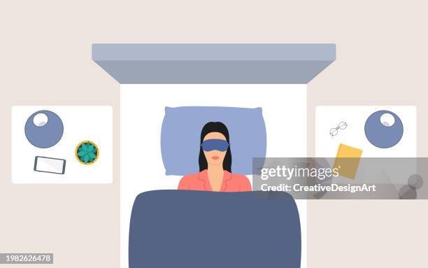 high angle view of woman sleeping with eye mask in double bed. modern bedroom with night tables, lampshades, succulent plant and book - sleep illustration stock illustrations