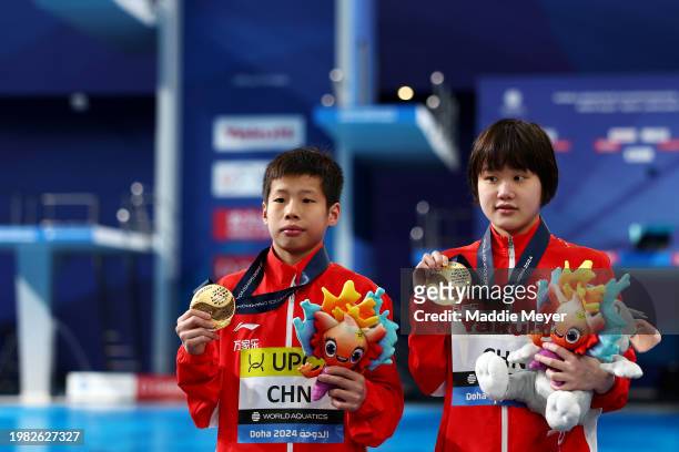Gold Medalists, Jianjie Huang and Jiaqi Zhang of Team People's Republic of China pose with their medals after the Medal Ceremony after the Mixed...