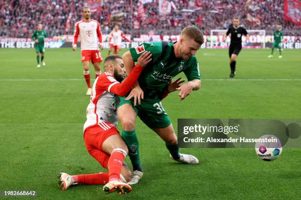Noussair Mazraoui of Bayern Munich clashes with Nico Elvedi of Borussia Moenchengladbach during the Bundesliga match between FC Bayern München and...