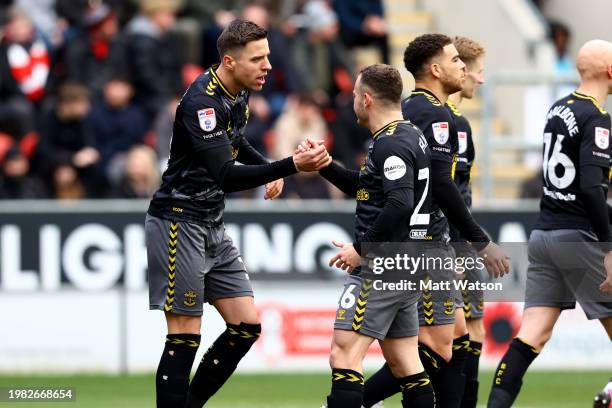 Jan Bednarek of Southampton is congratulated by team mate Ryan Fraser after opening the scoring during the Sky Bet Championship match between...