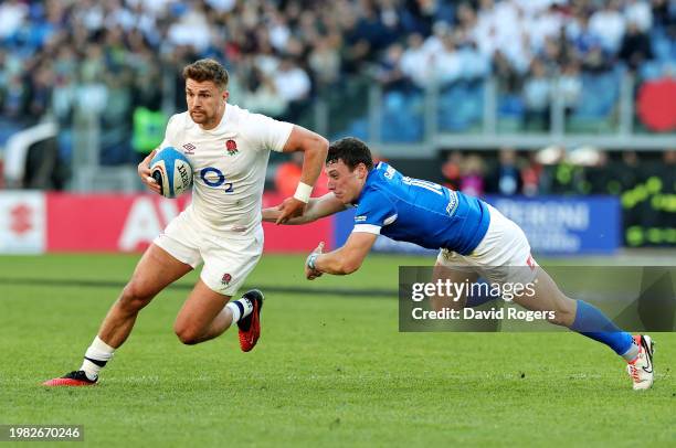 Henry Slade of England is tackled by Paolo Garbisi of Italy during the Guinness Six Nations 2024 match between Italy and England at Stadio Olimpico...