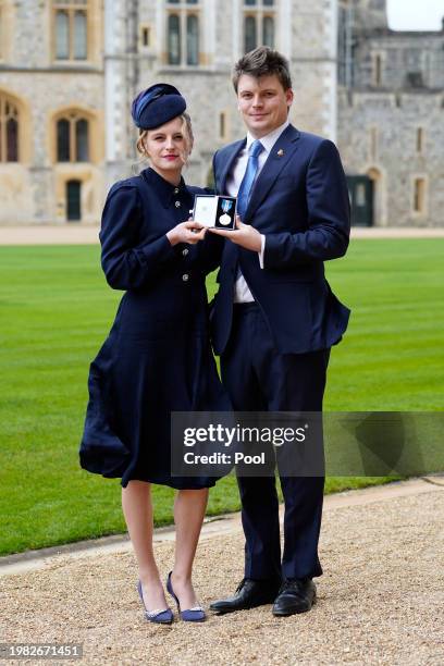 Madeleine Davidson-Houston with her brother Charles pose with the Queen's Gallantry Medal, awarded to her late grandfather, Mr. John Rees, by the...