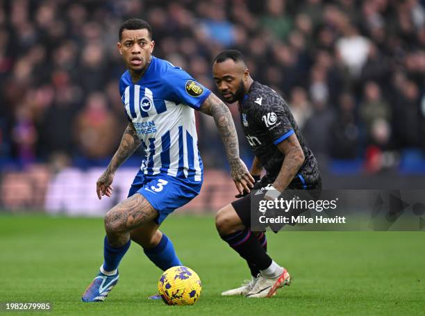 Igor of Brighton & Hove Albion is challenged by Jordan Ayew of Crystal Palace during the Premier League match between Brighton & Hove Albion and...