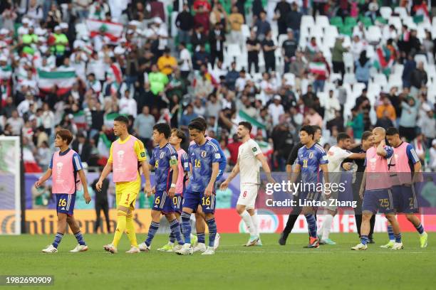 The players of Japan form a huddle at full-time following the teams defeat in the AFC Asian Cup quarter final match between Iran and Japan at...