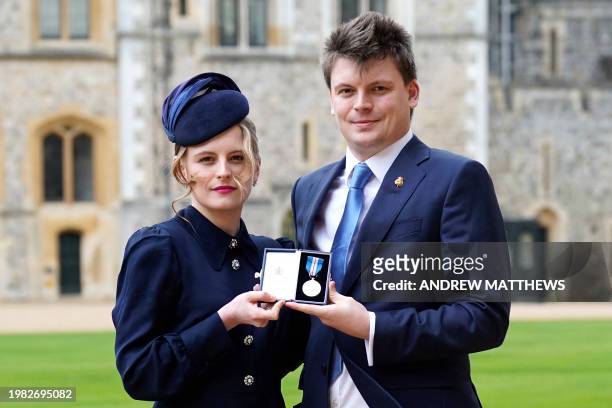 Madeleine Davidson-Houston and her brother Charles pose with their Queen's Gallantry Medal for their late grandfather, John Rees, following an...
