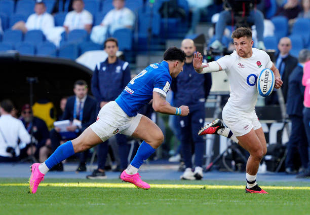 Henry Slade of England holds off Tommasao Menoncello of Italy during the Guinness Six Nations 2024 match between Italy and England at Stadio Olimpico...