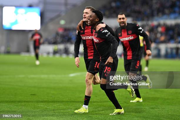 Nathan Tella of Bayer Leverkusen celebrates scoring his team's second goal with teammate Florian Wirtz during the Bundesliga match between SV...