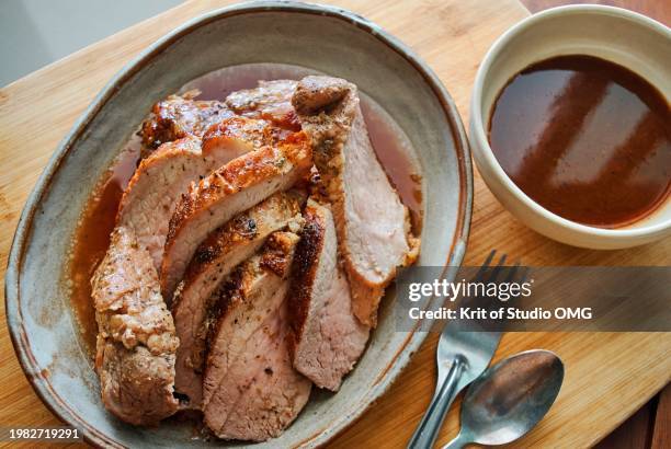 a plate of roasted pork slices - carne de cerdo fotografías e imágenes de stock