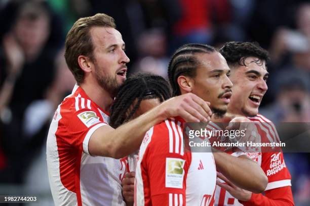 Harry Kane of Bayern Munich celebrates scoring his team's second goal with teammates Sacha Boey , Leroy Sane and Jamal Musiala during the Bundesliga...