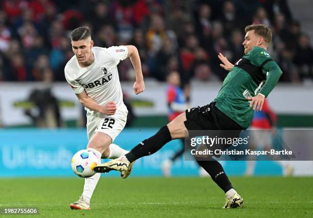 Roland Sallai of Sport-Club Freiburg and Maximilian Mittelstadt of VfB Stuttgart battle for the ball during the Bundesliga match between Sport-Club...