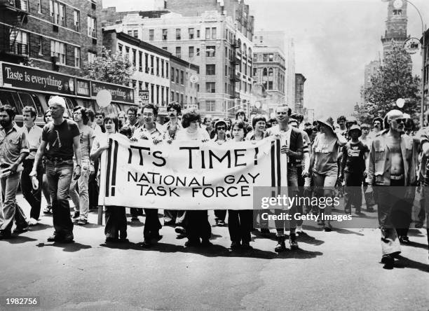 Group, led by several people carrying an 'It's Time! National Gay Task Force' banner, marches up Sixth Avenue during the annual Gay Pride parade in...