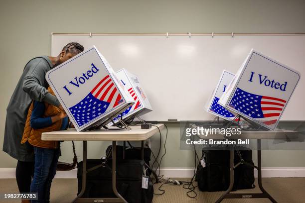 Aundrea Loftley and her son Andrew cast their ballot in the Democratic Primary at the Eastbridge Presbyterian Church on February 03, 2024 in Mount...
