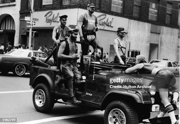 Group of men dressed in leather fetish clothing ride in a truck at the intersection of 32nd Street and Fifth Avenue during the annual Gay Pride...