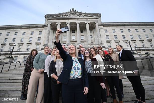 Northern Ireland First Minister Michelle O'Neill takes a 'selfie' with her elected Sinn Fein MLA's for a team Sinn Fein picture at Stormont on...
