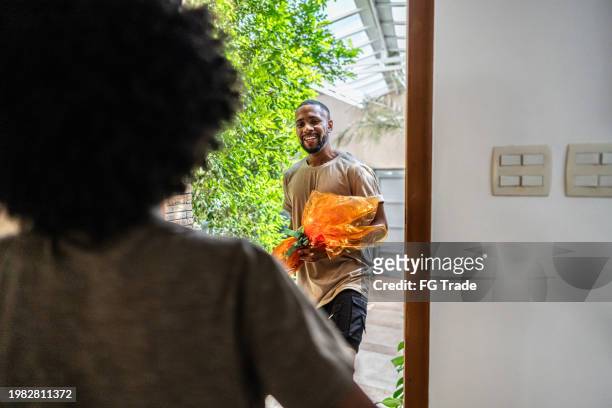 young man arriving for easter sunday at home - visit stock pictures, royalty-free photos & images