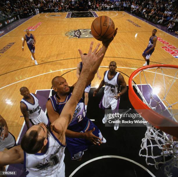John Amaechi of the Utah Jazz contests the defense of Vlade Divac of the Sacramento Kings in Game 5 of the Western Conference Quarterfinals during...