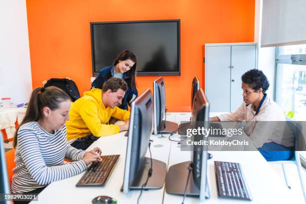 intellectual disabled students and teacher engaged in computer classroom activity - special education stock pictures, royalty-free photos & images