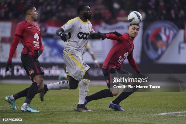 Aka Wilfried Kanga of Standard Liegi competes for the ball with Philipe Sampaio of RWDM Brussels FC during the Jupiler Pro League match between RWDM...
