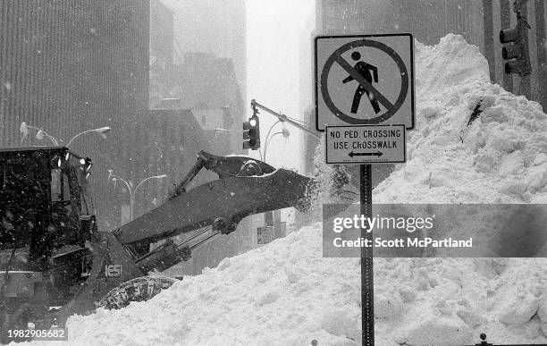 View of a snowplow piling snow into a mound on 5th Avenue during the President's Day blizzard, New York, New York, February 17, 2003.