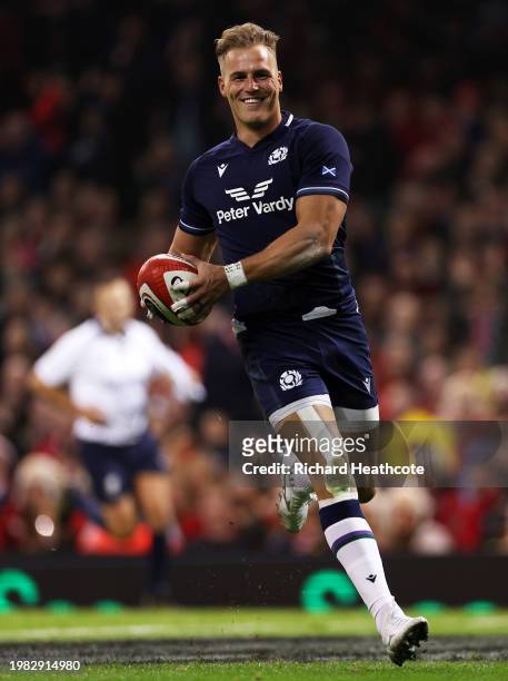 Duhan van der Merwe of Scotland runs to score his team's second try during the Guinness Six Nations 2024 match between Wales and Scotland at...