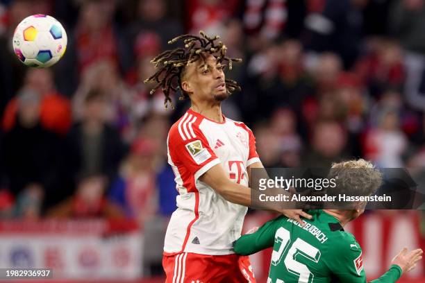 Sacha Boey of Bayern Munich competes for the ball with Robin Hack of Borussia Moenchengladbach during the Bundesliga match between FC Bayern München...