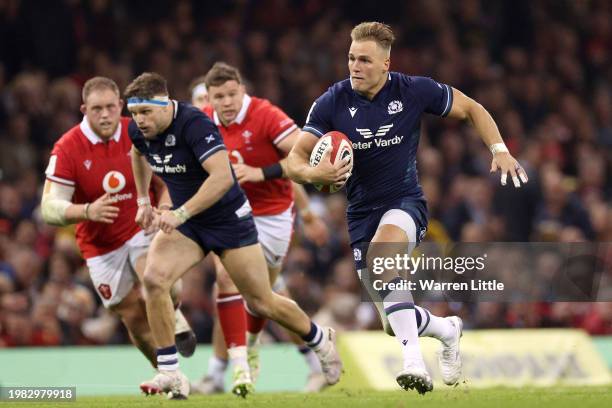 Duhan van der Merwe of Scotland breaks with the ball to score his team's third try during the Guinness Six Nations 2024 match between Wales and...