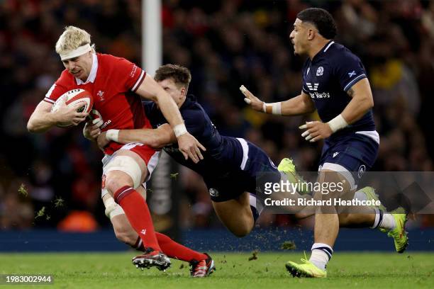 Aaron Wainwright of Wales is tackled by Huw Jones of Scotland during the Guinness Six Nations 2024 match between Wales and Scotland at Principality...