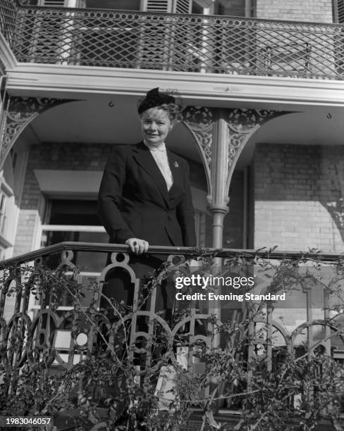 British politician Patricia Hornsby-Smith, Parliamentary Secretary to the Ministry of Health, poses behind a balustrade during the Conservative Party...