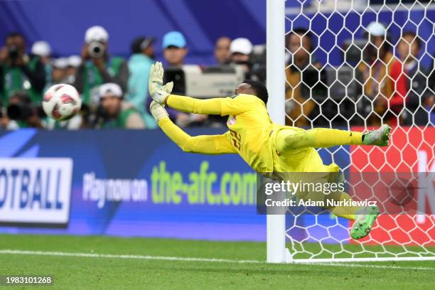 Meshaal Barsham of Qatar saves the fourth penalty from Zafarmurod Abdurakhmatov of Uzbekistan in the penalty shoot out during the AFC Asian Cup...