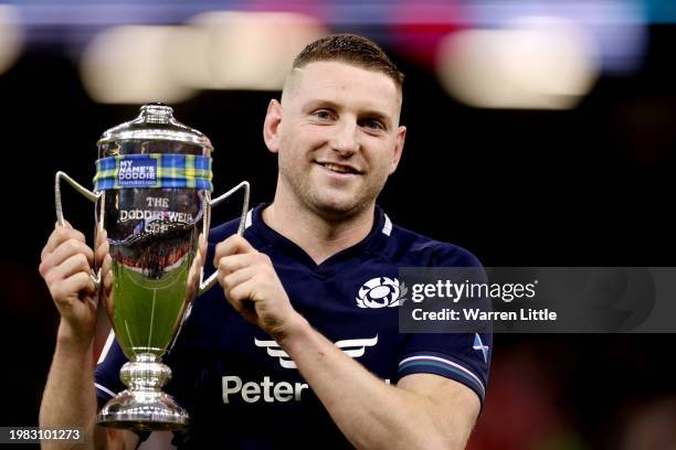 Finn Russell of Scotland poses for a photo with the Doddie Weir Cup trophy following the teams victory in the Guinness Six Nations 2024 match between...