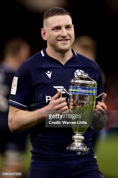 Finn Russell of Scotland poses for a photo with the Doddie Weir Cup trophy following the teams victory in the Guinness Six Nations 2024 match between...