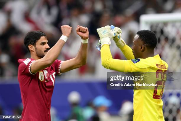 Sultan Al-Brake of Qatar interacts with Meshaal Barsham of Qatar during the AFC Asian Cup quarter final match between Qatar and Uzbekistan at Al Bayt...