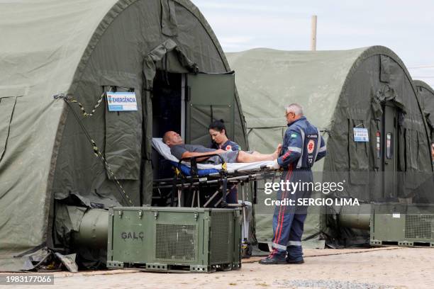 Patient is transferred to a hospital after receiving medical care at an improvised military aid station set up to treat suspected cases of dengue...