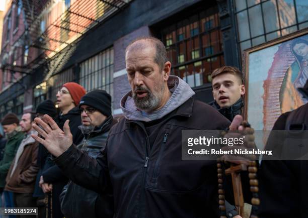 Monk from the Franciscan Friars of the Renewal, center, recites a prayer with anti-abortion activists near the Planned Parenthood clinic where they...