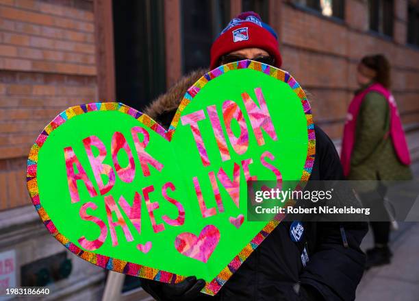 An abortion rights activist holds a sign near the entrance to the Planned Parenthood clinic on February 3, 2024 in New York City. The protests, which...