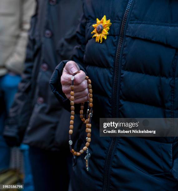 Woman holding rosary beads recites a prayer with anti-abortion activists near the Planned Parenthood clinic where they are confronted by abortion...