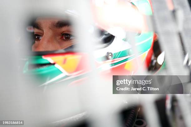 Salvador De Alba, driver of the Aga Red Cola Ford, sits in his car during practice for the NASCAR Mexico Series King Taco La Batalla en El Coliseo at...