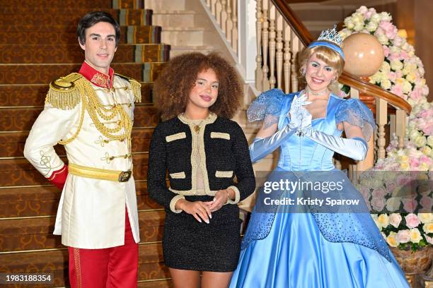 Paola Locatelli poses with Disney characters Prince Charming and Cinderella for the red carpet in the lobby of the Disneyland Hotel during the...