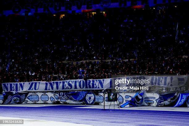 Fans of Hamburger SV hold up a banner in protest of the DFL investor during the Second Bundesliga match between Hertha BSC and Hamburger SV at...