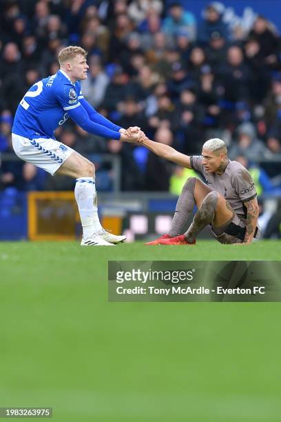Jarrad Branthwaite of Everton helps Richarlison to his feet during the Premier League match between Everton FC and Tottenham Hotspur at Goodison Park...