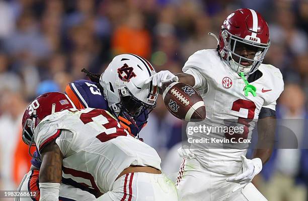 Rivaldo Fairweather of the Auburn Tigers fails to pull in this reception as he is hit by Jihaad Campbell and Terrion Arnold of the Alabama Crimson...