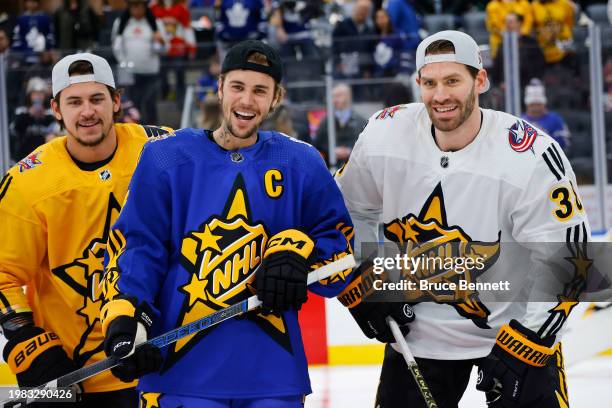 Travis Konecny of the Philadelphia Flyers, Celebrity Captain Justin Bieber of Team Matthews and Boone Jenner of the Columbus Blue Jackets poses for a...